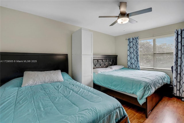 bedroom featuring a ceiling fan and wood finished floors