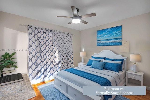 bedroom with a ceiling fan and wood finished floors