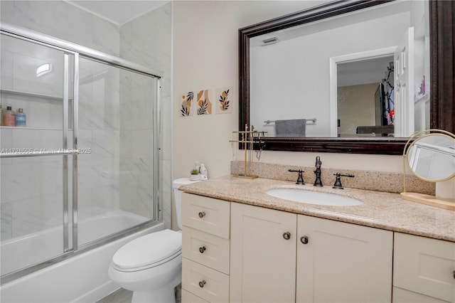 full bath featuring toilet, visible vents, shower / bath combination with glass door, and vanity