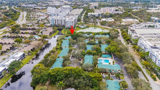 drone / aerial view featuring a view of city and a water view