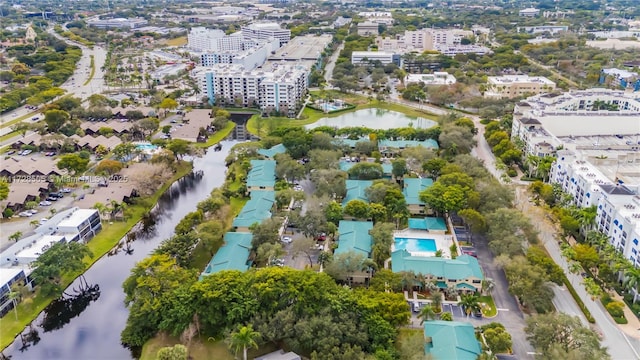 birds eye view of property with a water view and a city view