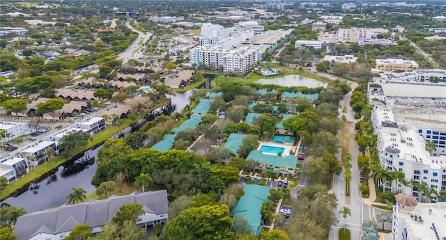 birds eye view of property featuring a view of city and a water view