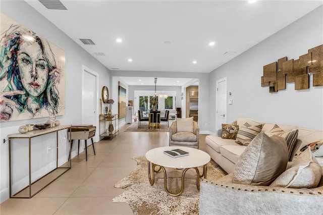 living area with light tile patterned floors, recessed lighting, visible vents, and baseboards