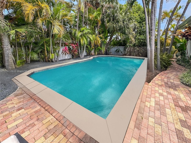 view of swimming pool with a fenced in pool and a fenced backyard