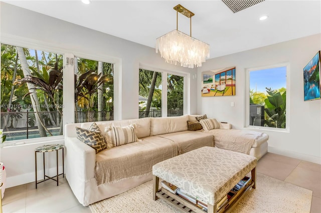 living room with a notable chandelier, visible vents, recessed lighting, and baseboards