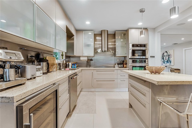 kitchen with wall chimney range hood, appliances with stainless steel finishes, a sink, beverage cooler, and modern cabinets
