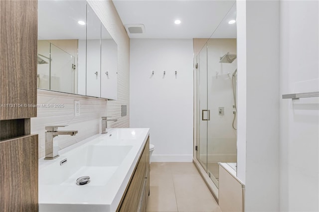 bathroom with a sink, tasteful backsplash, a stall shower, and double vanity