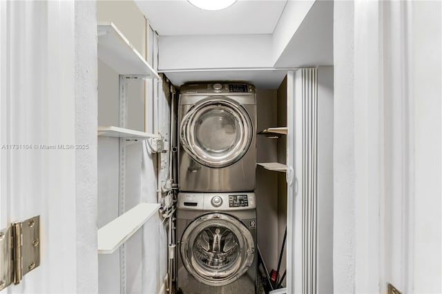 laundry room with laundry area and stacked washer / dryer