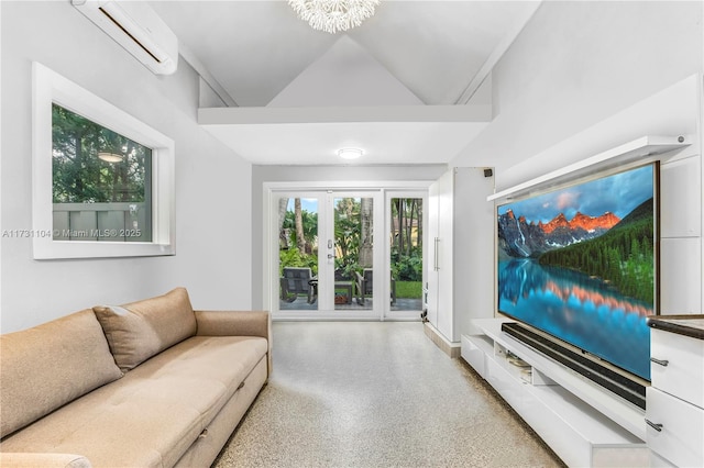 living room featuring lofted ceiling, speckled floor, and a wall unit AC