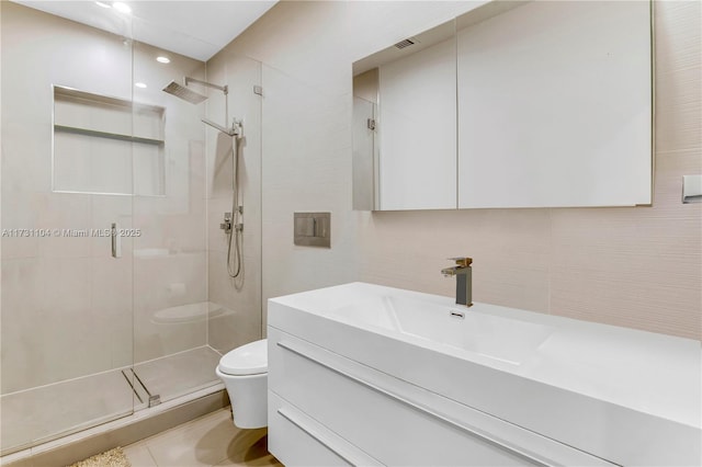 bathroom featuring tile walls, a shower stall, vanity, toilet, and recessed lighting