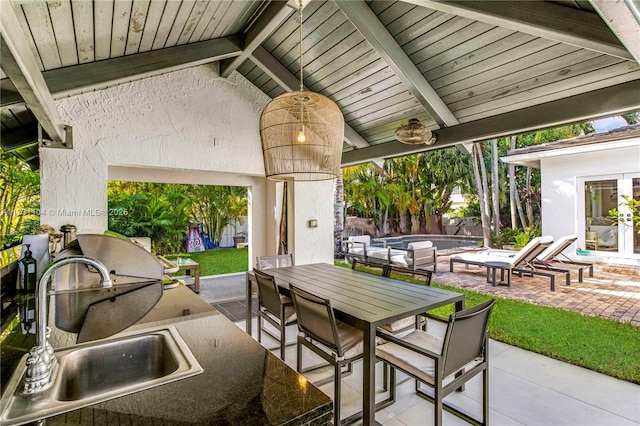 view of patio with outdoor dining space, french doors, an outdoor pool, and a sink