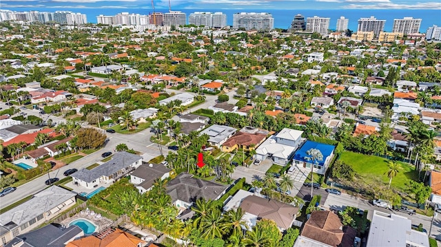 birds eye view of property featuring a water view and a city view