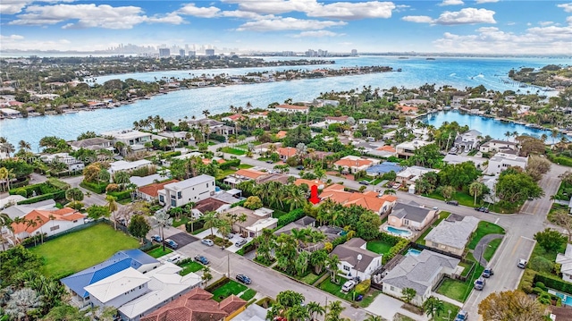 bird's eye view featuring a water view and a residential view