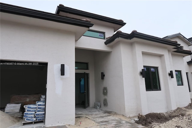 view of exterior entry with a garage