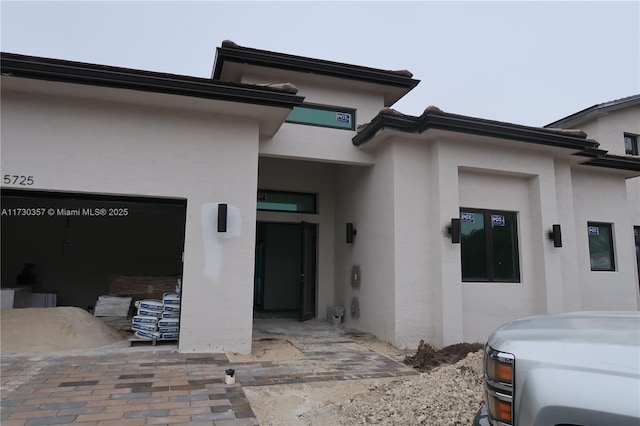 doorway to property with a garage