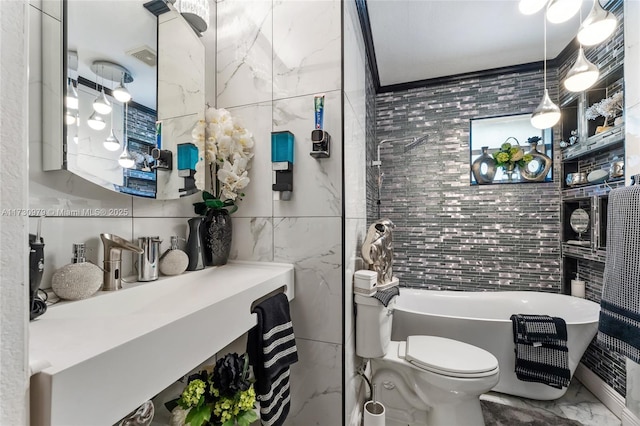 bathroom with toilet, a bath, vanity, and tile walls