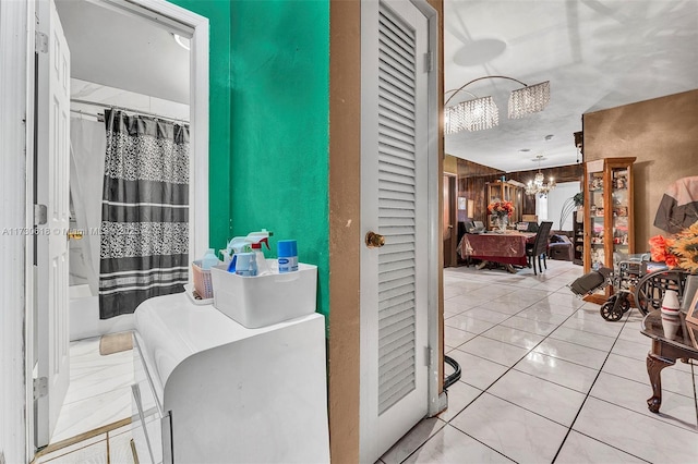 bathroom featuring shower / tub combo, a chandelier, and tile patterned flooring