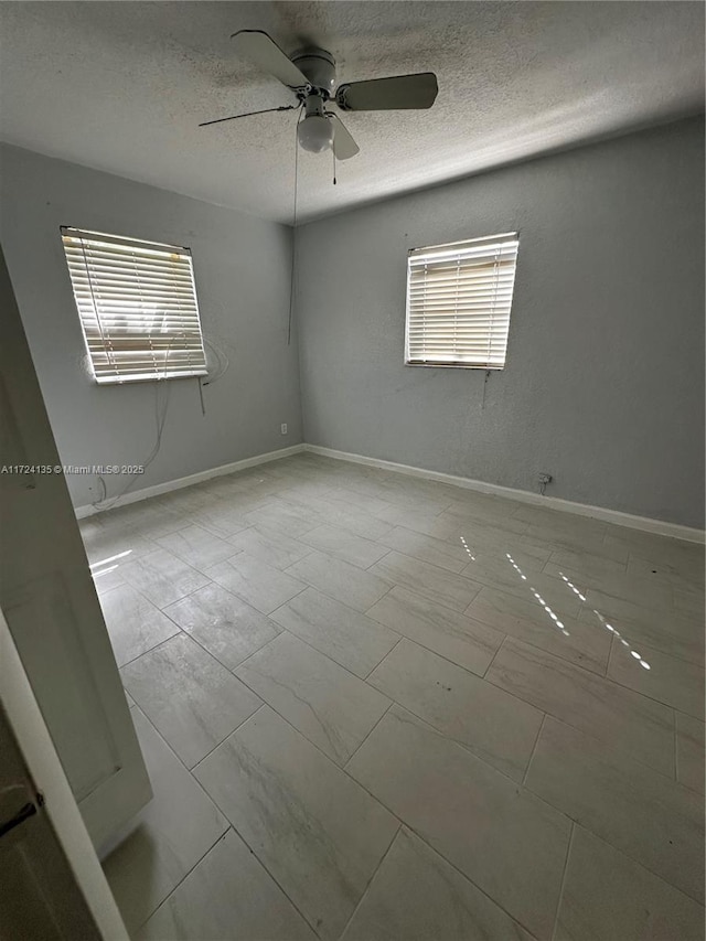 unfurnished room featuring ceiling fan