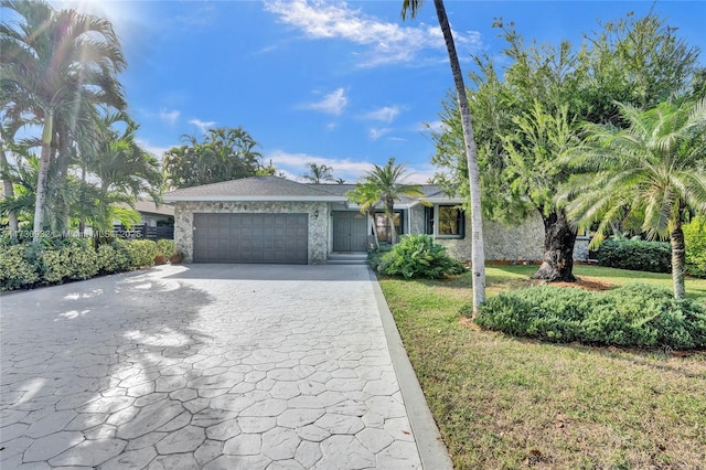 view of front of home featuring a garage and a front yard