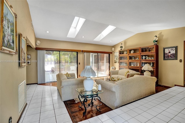 living room featuring light tile patterned floors and vaulted ceiling with skylight