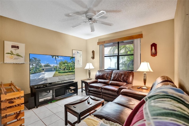 living room featuring ceiling fan, a textured ceiling, and light tile patterned flooring