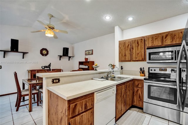 kitchen featuring sink, stainless steel appliances, kitchen peninsula, and light tile patterned flooring