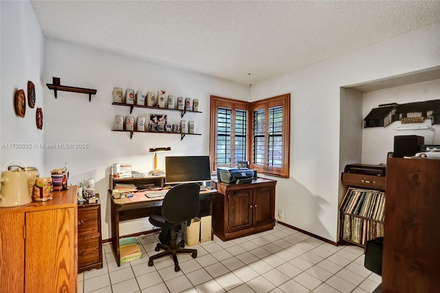 office with light tile patterned floors and a textured ceiling