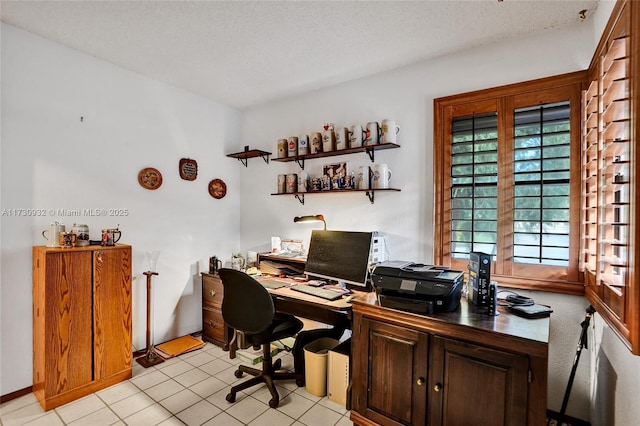 home office with light tile patterned floors and a textured ceiling