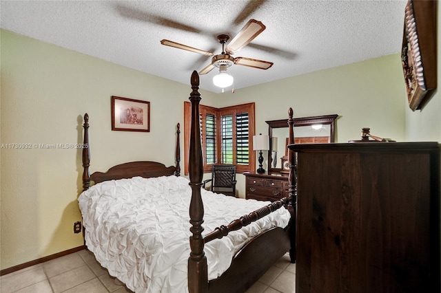 bedroom with ceiling fan, a textured ceiling, and light tile patterned flooring