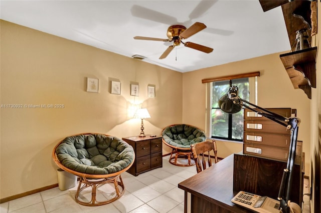 tiled office space featuring ceiling fan