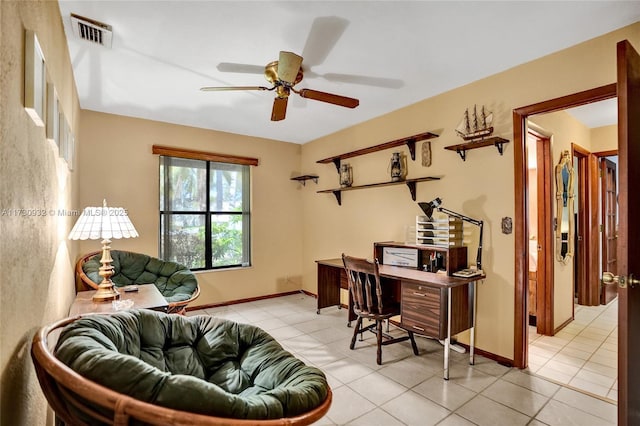 tiled home office featuring ceiling fan