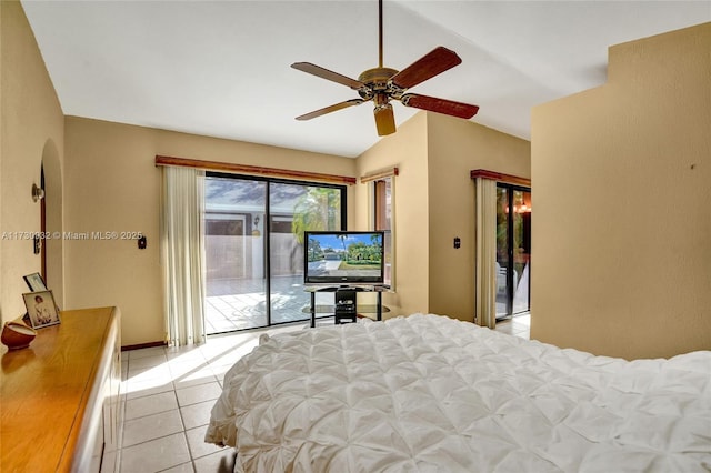 bedroom with ceiling fan, lofted ceiling, light tile patterned floors, and access to outside