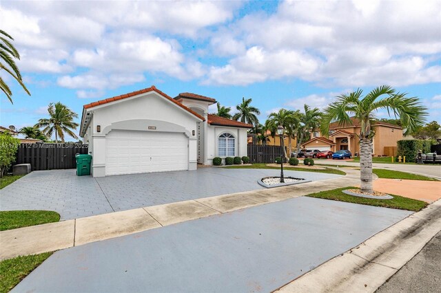 mediterranean / spanish home with a garage