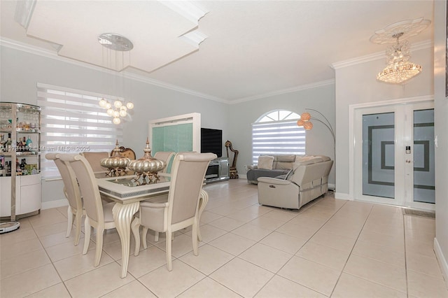 dining room featuring an inviting chandelier, ornamental molding, and light tile patterned flooring