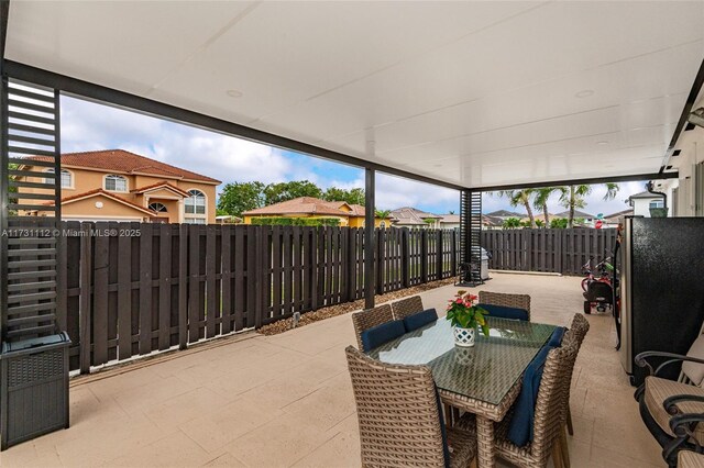 view of patio / terrace with french doors, a water view, and a storage shed