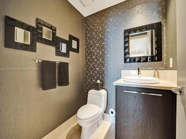 17121 Collins Ave Unit 3905, Sunny Isles Beach, FL 33160 - half bath featuring toilet, vanity, wallpapered walls, and tile patterned floors
