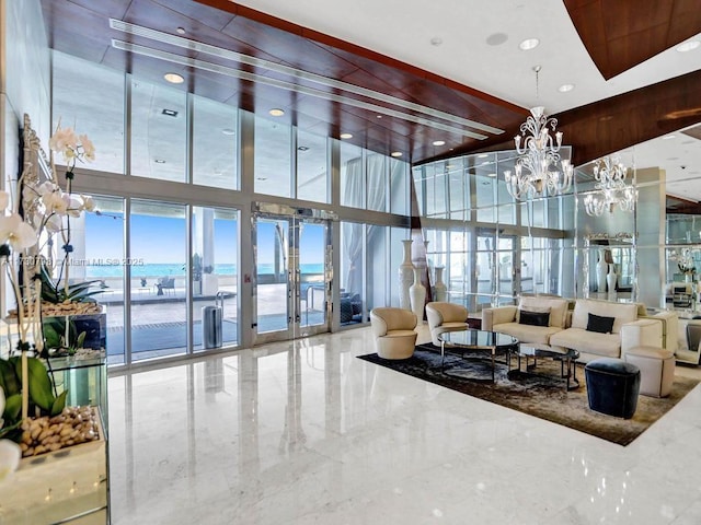 17121 Collins Ave Unit 3905, Sunny Isles Beach, FL 33160 - common area with a towering ceiling, a water view, a wall of windows, and recessed lighting