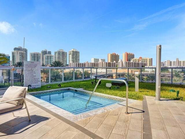 17121 Collins Ave Unit 3905, Sunny Isles Beach, FL 33160 - view of swimming pool with a skyline view and a hot tub