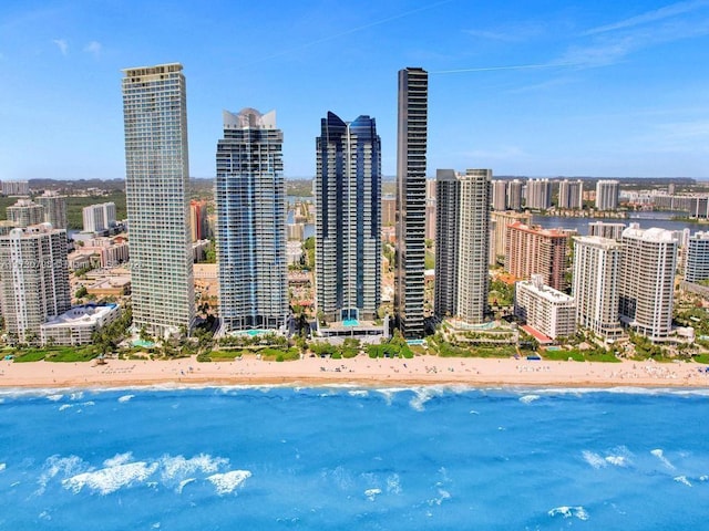 property's view of city featuring a water view and a view of the beach