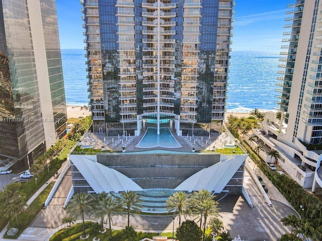 view of property featuring a water view and a view of the beach