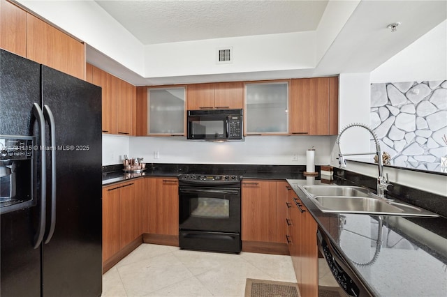 kitchen with sink, black appliances, and a textured ceiling