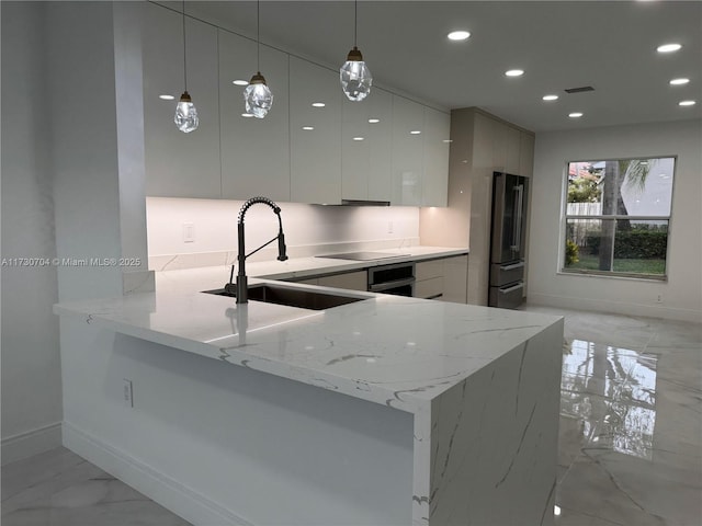 kitchen with modern cabinets, visible vents, recessed lighting, marble finish floor, and a sink