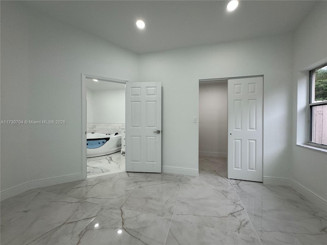 unfurnished bedroom with recessed lighting, marble finish floor, and baseboards