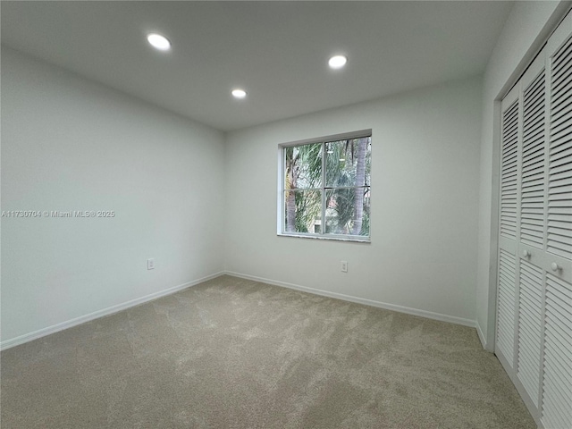 unfurnished bedroom featuring a closet, baseboards, recessed lighting, and carpet flooring