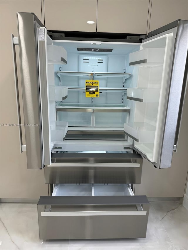 interior details featuring fridge, baseboards, and open shelves