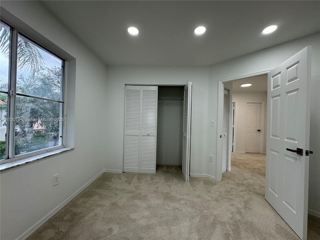 unfurnished bedroom featuring multiple windows, carpet, and recessed lighting