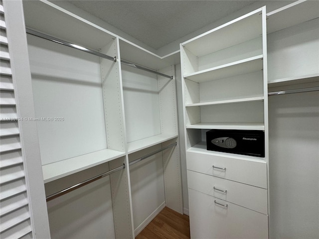 walk in closet featuring hardwood / wood-style floors