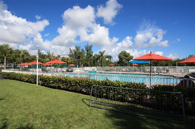 pool with a yard and fence