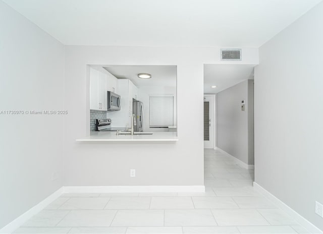 interior space with sink and light tile patterned floors