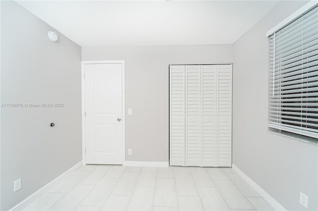 unfurnished bedroom with a closet